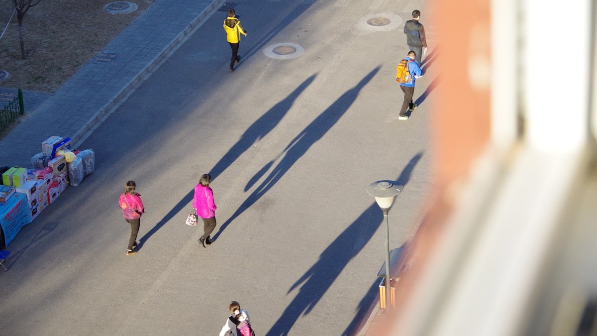 a group of people walking down a street
